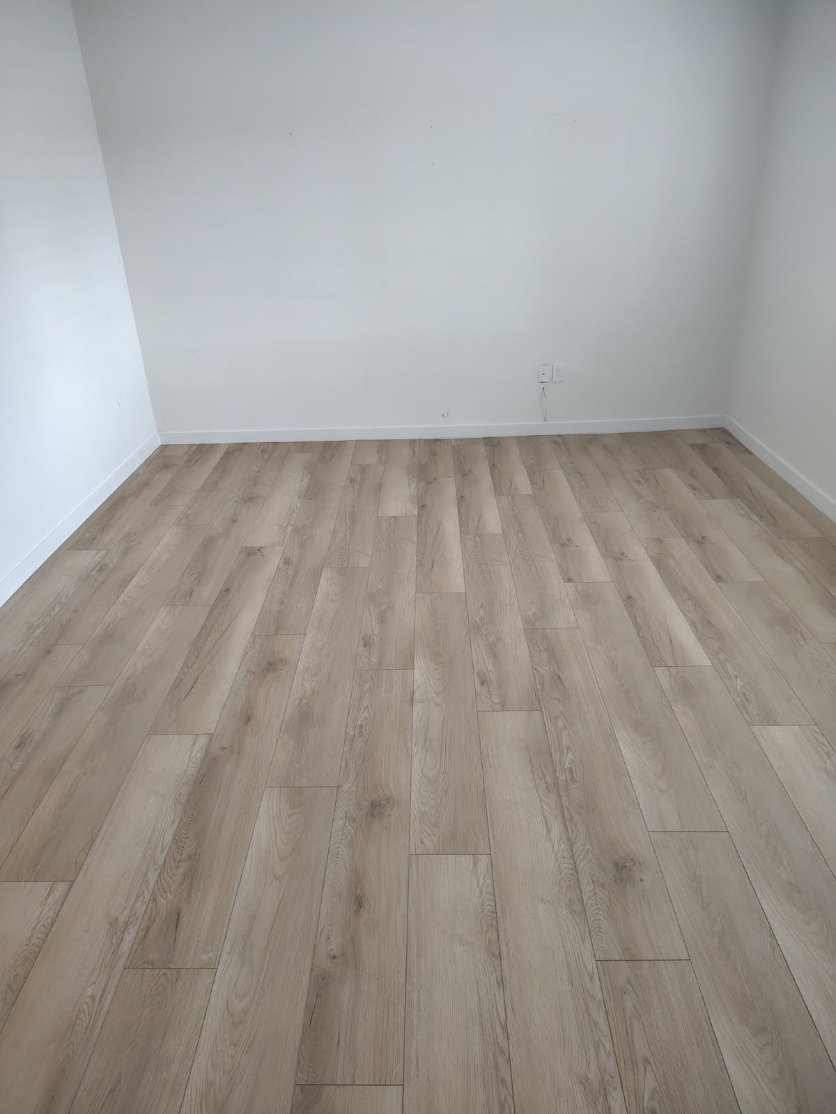 Bright, freshly finished living space with new flooring by Grayhawk Handyman
